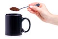 Black cup mug with spoon coffee in hand
