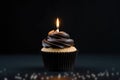 Black Cupcake With Lighted Candle On Black Background, Empty Space. Generative AI