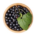 Black currant berries in wooden bowl isolated on white background Royalty Free Stock Photo