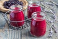 Black currant, greek yogurt, honey and lavender smoothie in jar with berries and flowers on background, horizontal Royalty Free Stock Photo