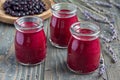 Black currant, greek yogurt, honey and lavender smoothie in jar with berries and flowers on background, horizontal Royalty Free Stock Photo