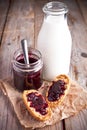 Black currant jam in glass jar, milk and crackers Royalty Free Stock Photo