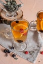 black currant tea with green leaves in a glass Cup in the autumn on the background of a window with raindrops on a white wooden Royalty Free Stock Photo