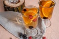 black currant tea with green leaves in a glass Cup in the autumn on the background of a window with raindrops on a white wooden Royalty Free Stock Photo