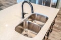 Black curved faucet over stainless steel undermount sink with double basins