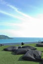 Black cushion outdoor on green grass seaview in blue sky Royalty Free Stock Photo