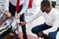 Black customer man asks questions about headlights of car