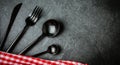 Black cutlery set, italian napkin on slate. Food background Top