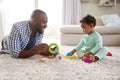 Black dad and toddler son playing on floor at home, close up Royalty Free Stock Photo
