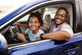 Black Daddy Teaching Preteen Daughter To Drive Smiling To Camera