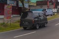 Black Daihatsu Zebra Van driving fast on the road