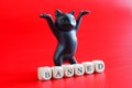 Black dancing toy cat and inscription banned on bright red background. Concept of banned internet forum, chat room, website,