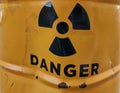 Nuclear danger sign on crumpled metal barrel
