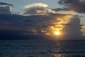 Black and Dark Red Clouds Under Sunlight Over the Ocean. The Sky Before a Thunderstorm, Storm. Dramatic Sky Royalty Free Stock Photo