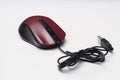 Black and dark red optical mouse, with USB cable. Royalty Free Stock Photo