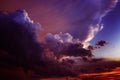 Black dark red purple magenta violet blue sky. Dramatic evening sunset background. Clouds storm wind lightning rain. Ominous.