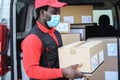 Black delivery man wearing safety mask for coronavirus prevention - Focus on face