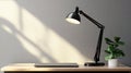 A black desk lamp with an adjustable arm, designed for focused lighting in workspaces Royalty Free Stock Photo