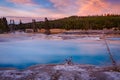 Black Diamond Pool in Biscuit basin with blue steamy water and beautiful colorful sunset. Yellowstone, Wyoming