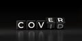 Black dice form the words COVID and COVER with Coronavirus Concept on dark background.