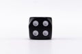 Black Dice with Four Spots on White Background, Game of Chance, Single Object Royalty Free Stock Photo