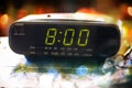 Black digital alarm radio clock.Alarm radio clock indicating time to wake up.Digital clock closeup displaying 8:00 o`clock.Digital Royalty Free Stock Photo