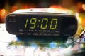 Black digital alarm radio clock.Alarm radio clock indicating time to wake up.Digital clock closeup displaying 19:00 Royalty Free Stock Photo