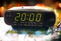 Black digital alarm radio clock.Alarm radio clock indicating time to wake up.Digital clock closeup displaying 20:00 Royalty Free Stock Photo