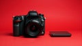 Black Digital Camera and External Drive on Red Royalty Free Stock Photo