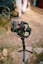 Black digital camera stands on a tripod on stones. View from above Royalty Free Stock Photo