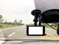 Black digital dashcam camera installed in the car near the rear