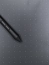 a black digital stylus touch pen tool on a sketching tablet