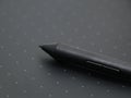 a black digital stylus touch pen tool on a sketching tablet