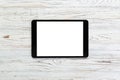 Black digital tablet on rustic wooden table background. mock up top view Royalty Free Stock Photo