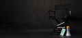 Black director chair , face mask, megaphone and Clapper board or movie slate on black background