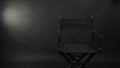 Black director chair and light isolated on black background