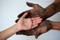 Black dirty man hands holding kid clean hand