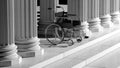 Black disability wheelchair, with ancient pillars Royalty Free Stock Photo