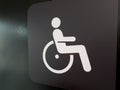 Black disabled sign with white symbol of wheelchair user. Wall sign for people with mobility issues. Concept for accessible Royalty Free Stock Photo
