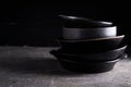 Black dishes on a black stone table