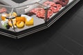Black display case with meat and cheeses.