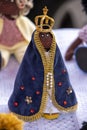 black doll of the patron saint of Brazil, Nossa Senhora Aparecida smiling with the blue and yellow mantle