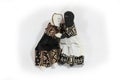 Black doll and white doll embrace concept forgiveness, reconciliation