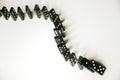 Black dominoes chain on white table background Royalty Free Stock Photo