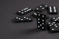 Black Dominoes on dark background, Closeup scattered dominoes on a gray, table. Board game, Game night Dominos table game Royalty Free Stock Photo