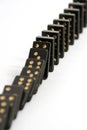 Black Dominoes Falling Down in a Line Royalty Free Stock Photo