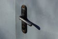 Black door knob on a gray metal door Royalty Free Stock Photo