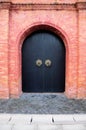 Black Double Doors and Brick Wall