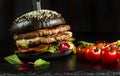 Black double hamburger made from beef, with jalapeno pepper. Royalty Free Stock Photo