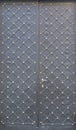 Black double metal doors with rhombic pattern and rivets. Royalty Free Stock Photo